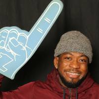 student uses foam finger for a picture